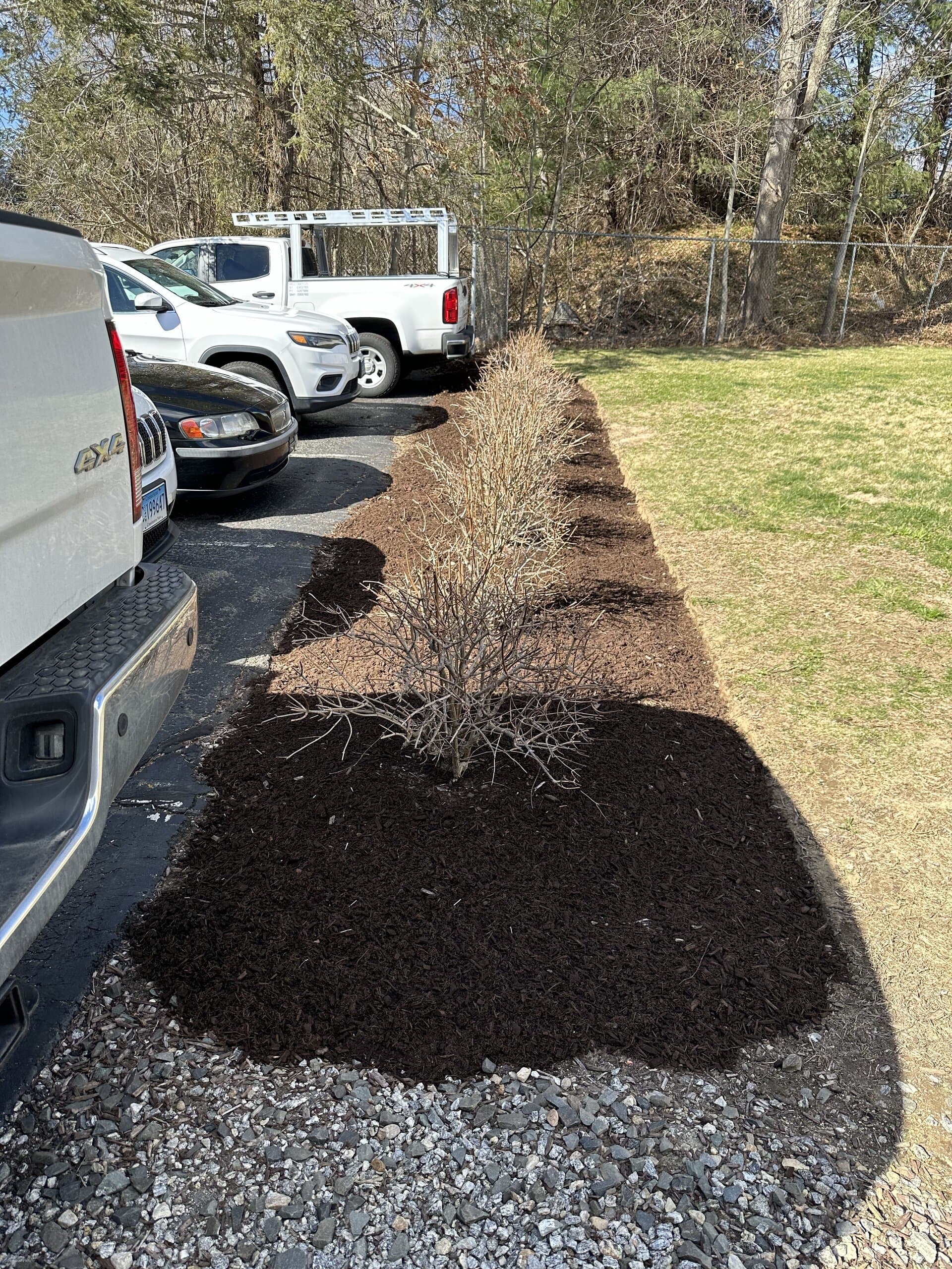 Freshly mulched garden bed along a driveway